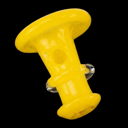 Close-up angled view of the Empire Glassworks PuffCo 'New Peak' & Proxy Glass Joystick Cap - Sunshine Yellow showing its glossy yellow mushroom-shaped top and clear side knobs against a black background