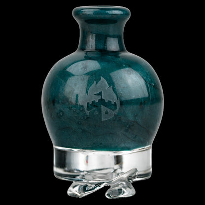 Close-up front view of the Empire Glassworks Puffco Pivot Glass Mouthpiece - Blue Lagoon showing its glossy teal bulbous top, subtle logo, and clear glass base against a black background.