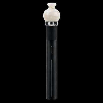 Centered vertical close-up of the Empire Glassworks Puffco Pivot Glass Mouthpiece - Glow in the Dark showing a cream rounded glass tip seated in a clear collar atop a matte black stem against a black background