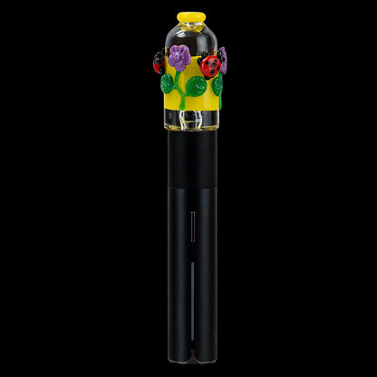 Centered close-up of the Empire Glassworks Puffco Pivot Glass Mouthpiece - Sunshine Garden showing a yellow banded glass top with purple flowers and red ladybugs against a black background