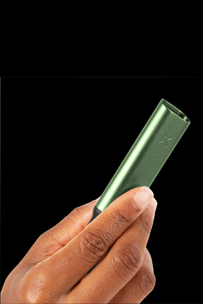 A hand holding a sleek, metallic green cannabis vaporizer pen against a black background.