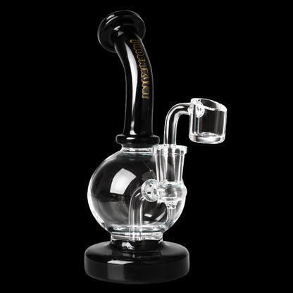 Three-quarter view of the Green Flower Phoenix Star 7 Inch Shorty Ball Rig With Insert Perc showing a clear spherical chamber, black curved neck with gold script, and a clear banger against a black background