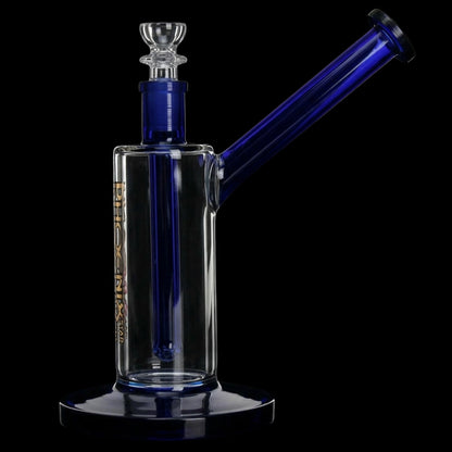 Close-up, three-quarter view of the Green Flower Phoenix Star 7 Inch Bubbler Rig showing its clear body, angled cobalt-blue neck and matching blue mouthpiece against a black background