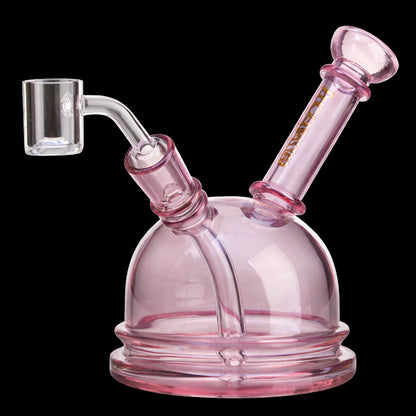 Close-up angled view of the Green Flower Phoenix Star 6 Inch Translucent Dome Dab Rig in pink glass showing the dome, angled mouthpiece, and clear banger against a black background
