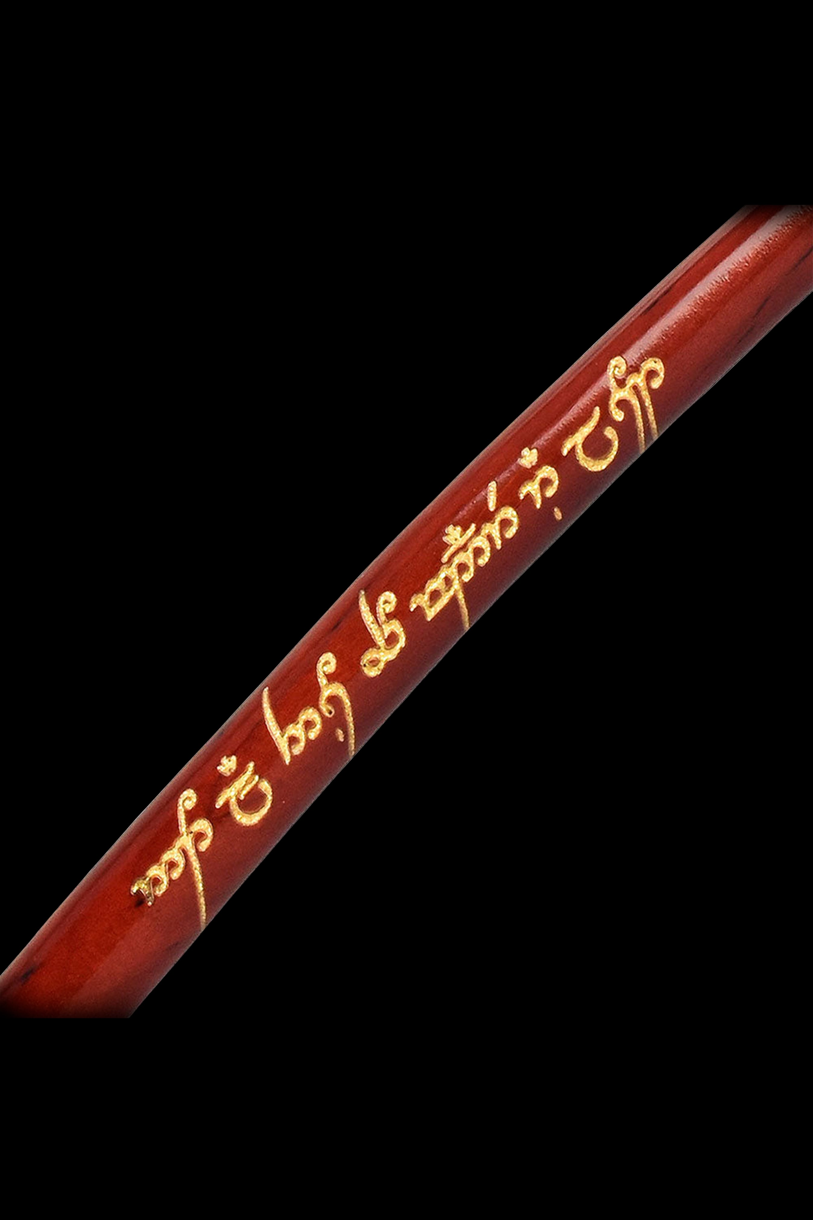 Red wooden dugout with gold-colored Elvish script.