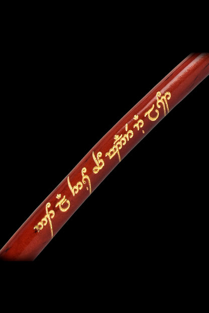 Red wooden dugout with gold-colored Elvish script.