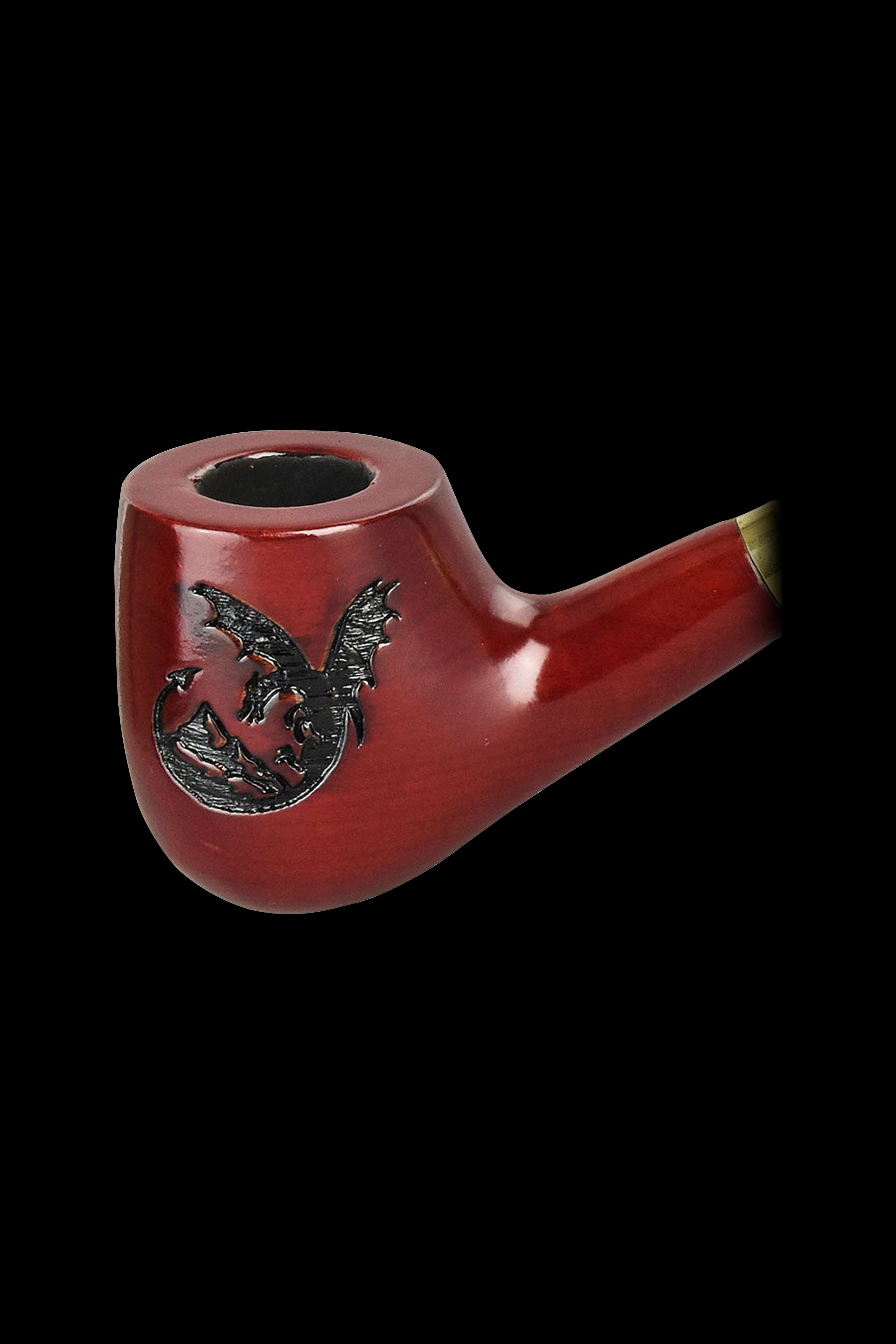 Red glass pipe with a dragon design, isolated on a black background.
