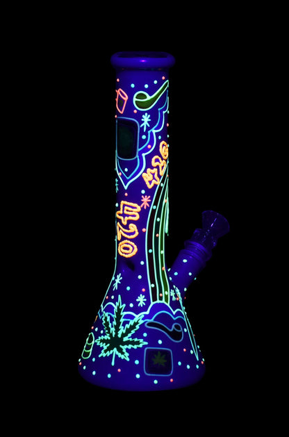 Glowing glass bong with cannabis leaf and “420” designs on a black background.