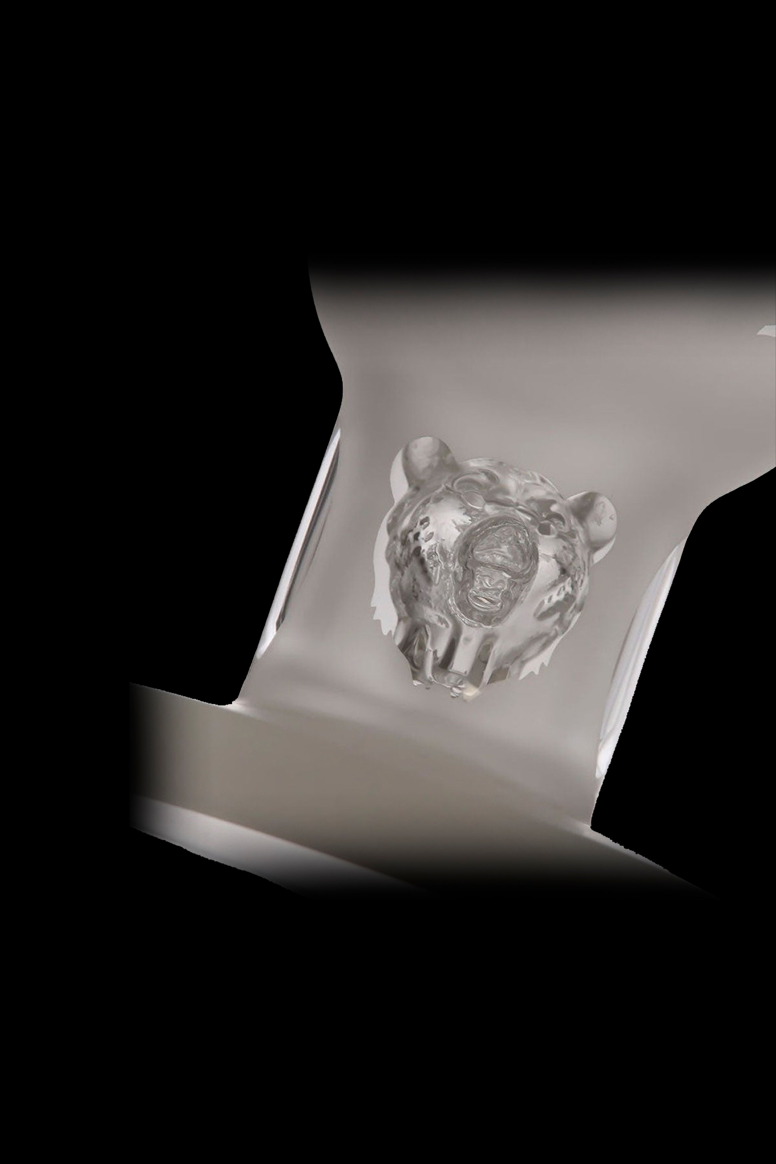 A glass cannabis bubbler with a bear-shaped design, displayed against a black background.