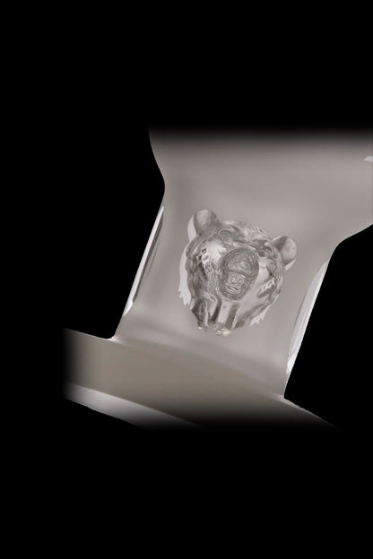 A glass cannabis bubbler with a bear-shaped design, displayed against a black background.