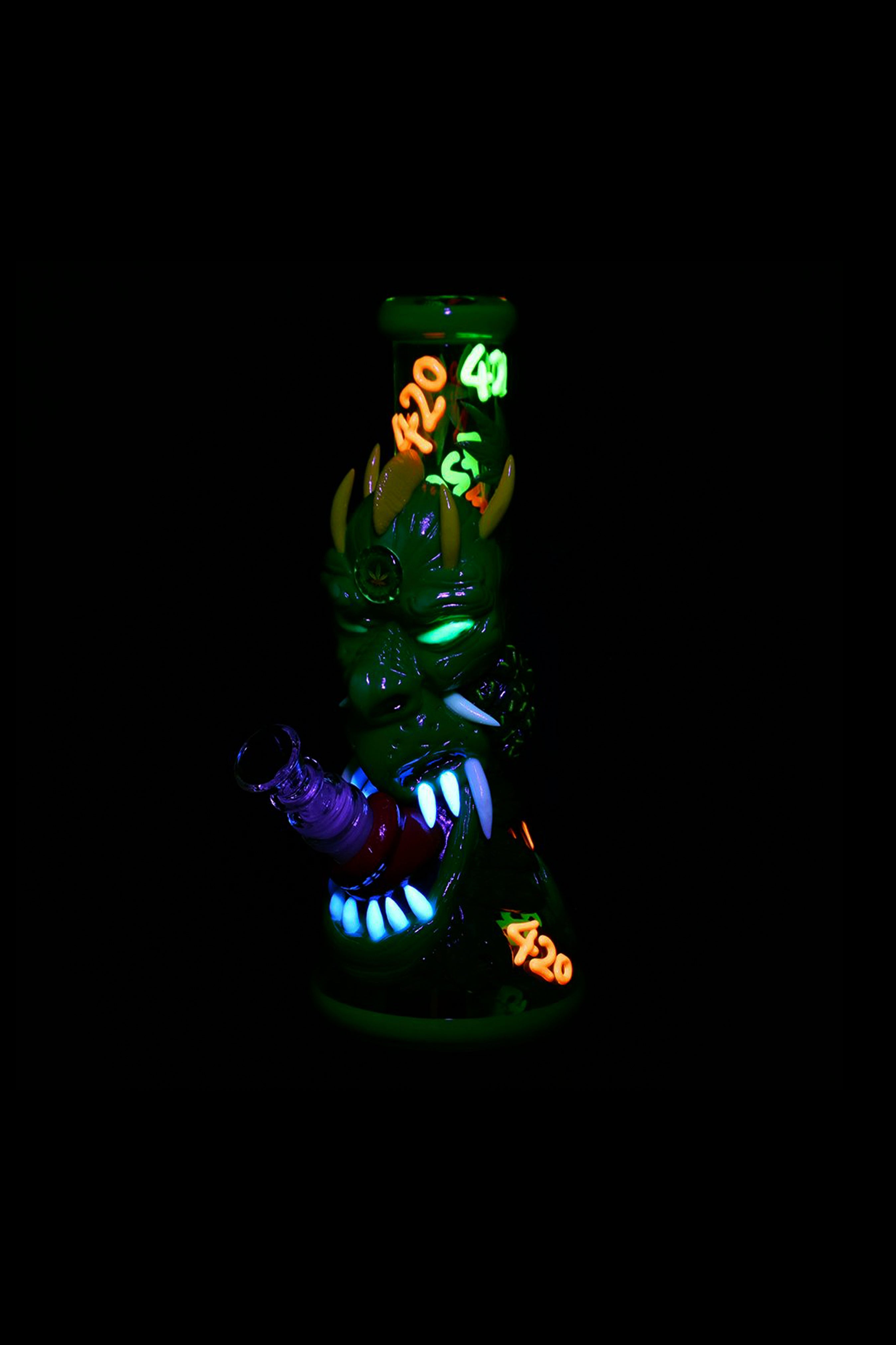 Glowing green glass bong with claw-like accents and “420” text, set against a black background.