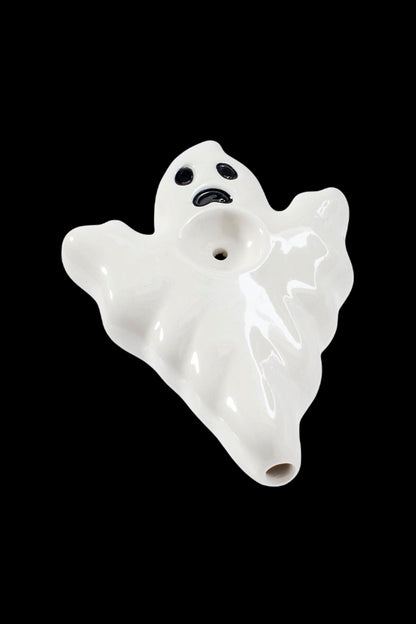 White ceramic ghost-shaped smoking pipe against a black background.