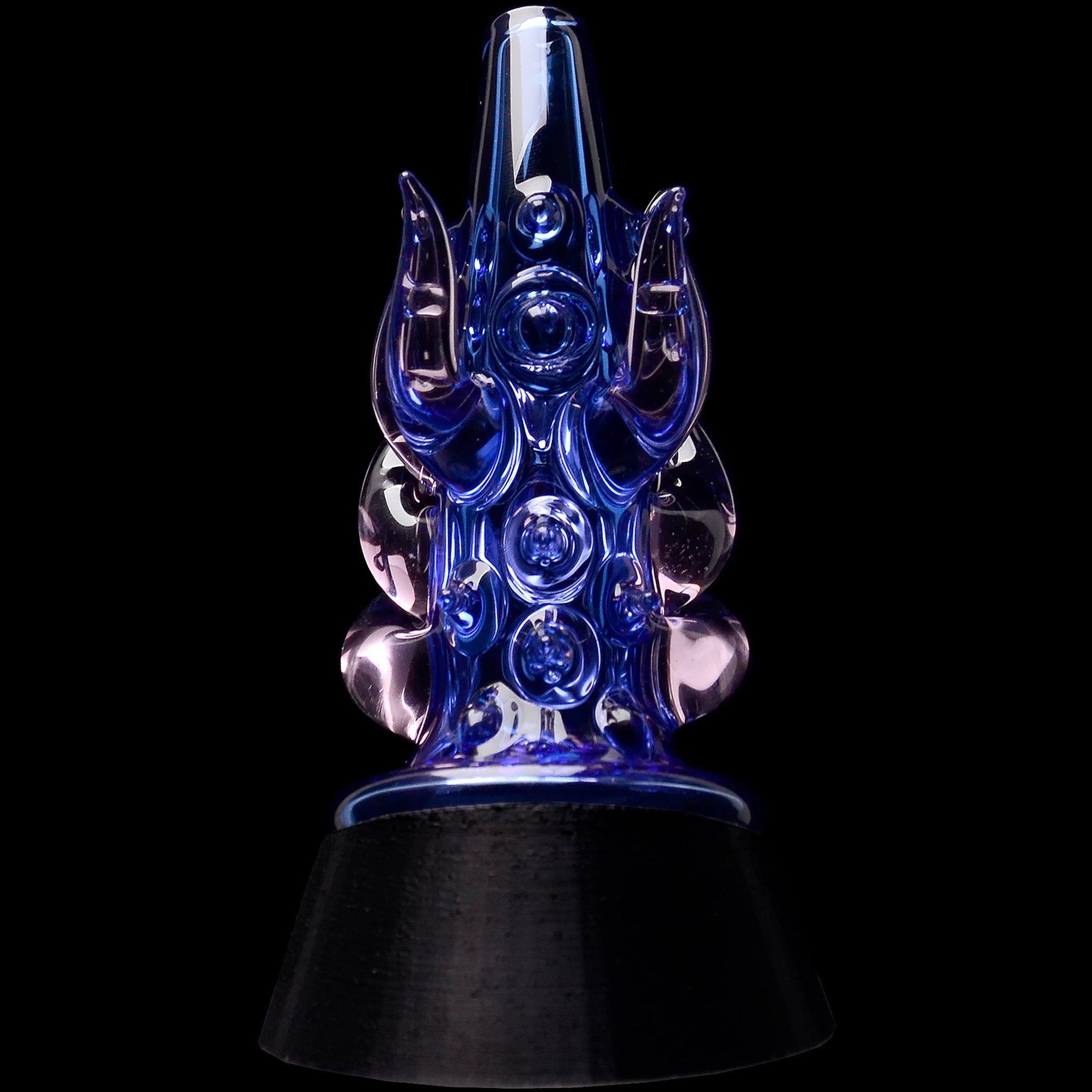 Close-up front view of the Glassic Cosmic Tentacle Puffco Peak Glass Attachment in transparent black showing glossy blue-tinted tentacle details against a black background