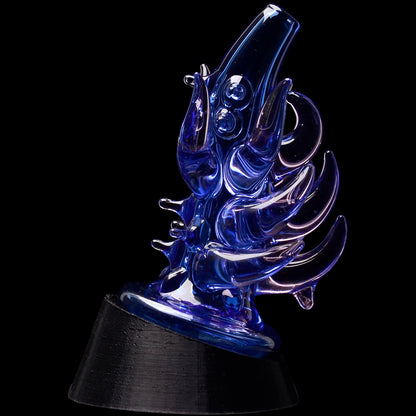 Close-up, angled view of the Glassic Cosmic Tentacle Puffco Peak Glass Attachment showing iridescent yellow-blue glass tentacles against a black background