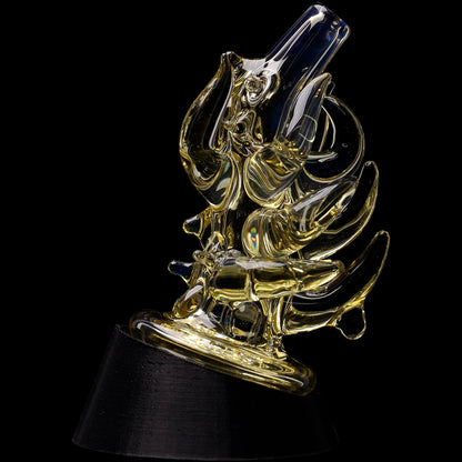 Close-up angled view of the Glassic Cosmic Tentacle Puffco Peak Glass Attachment showing glossy, golden-tinted glass tentacle forms against a black background