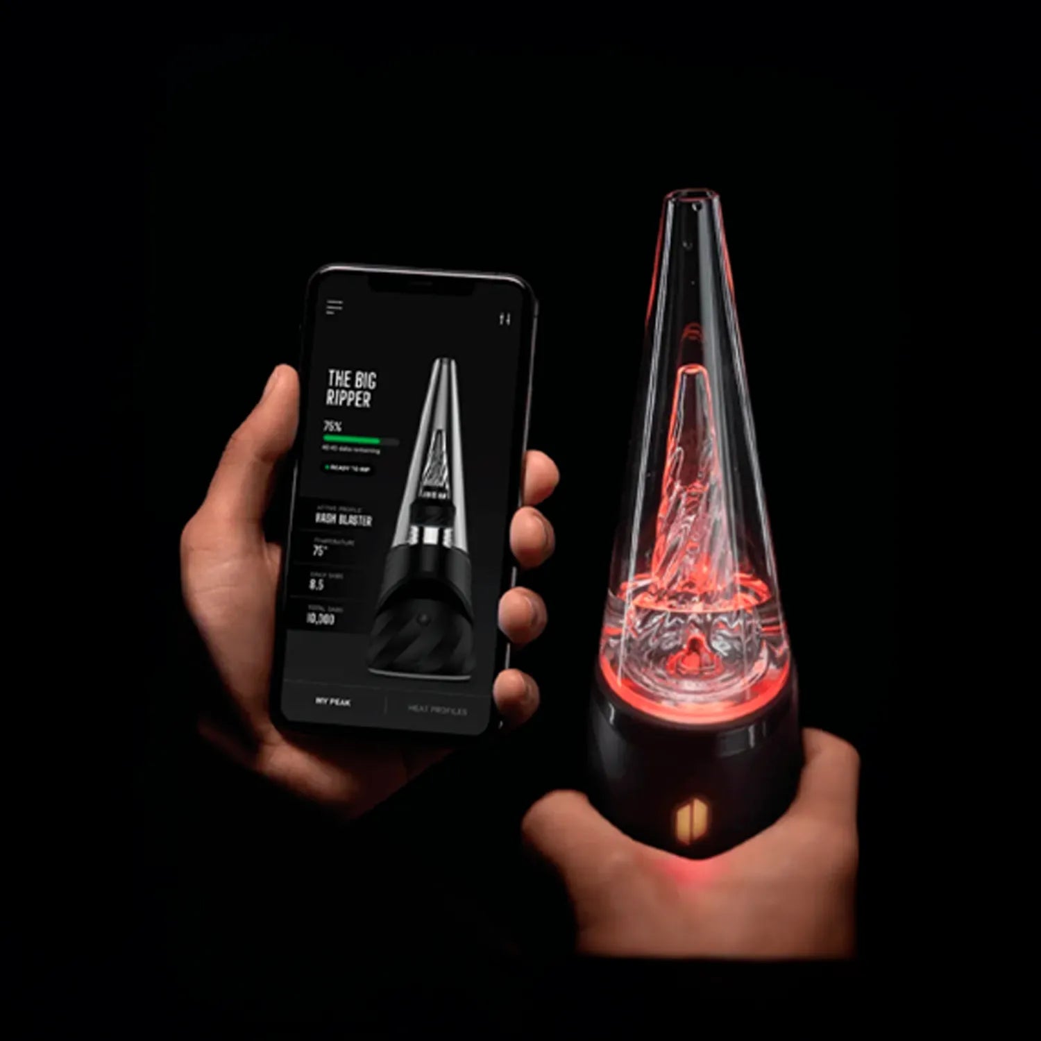 Hands hold a phone showing app controls and the illuminated conical glass chamber of the Puffco New Peak Pro with 3D XL Chamber.