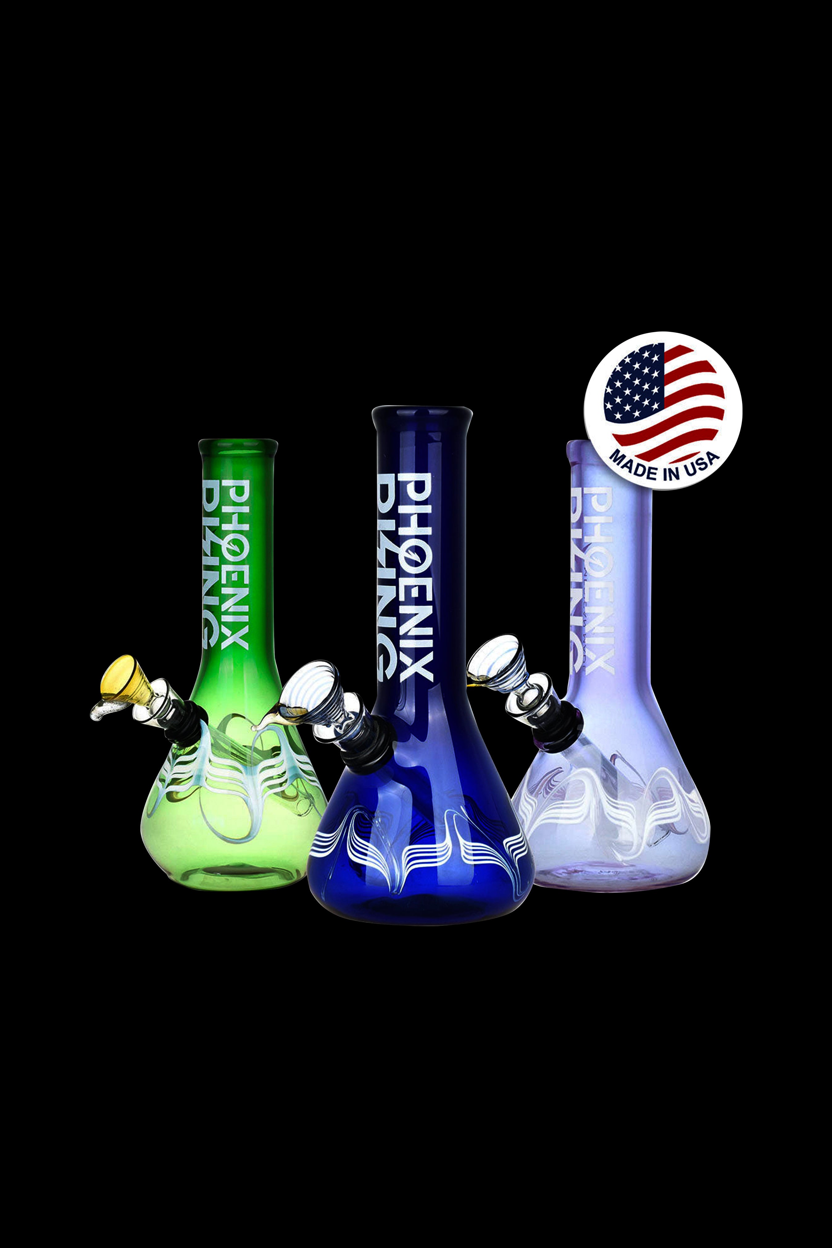 Three colorful glass bongs with Phoenix branding, displayed against a black background, and a "Made in USA" badge.