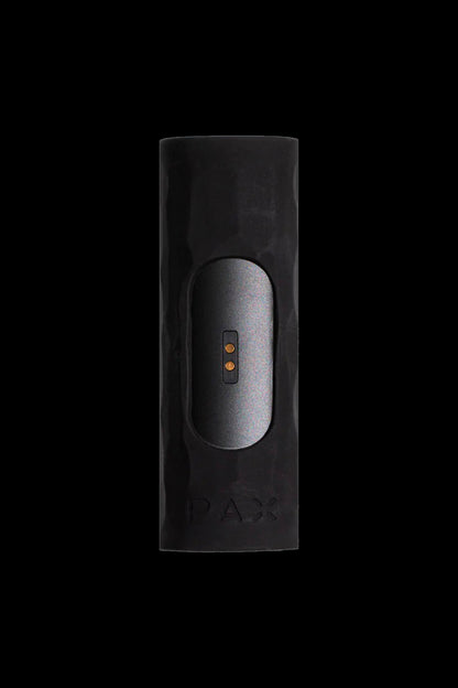 Black Pax vaporiser with illuminated controls, against a dark background.