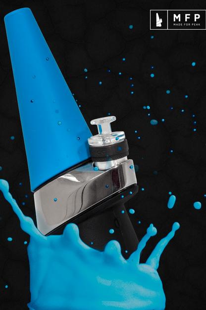 A vibrant blue cannabis e-rig with splashing blue liquid against a dark background.