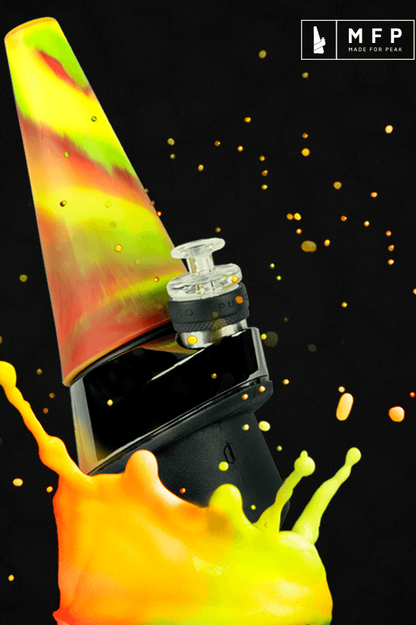 Colorful glass dab rig with a black electronic nail, splashed with golden liquid against a dark background.