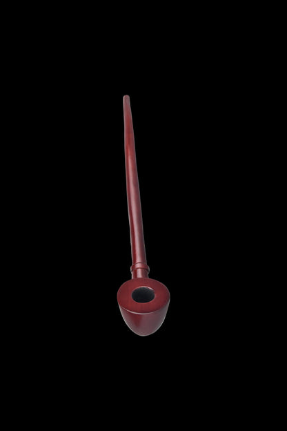Red wooden pipe for smoking cannabis, isolated on a black background.