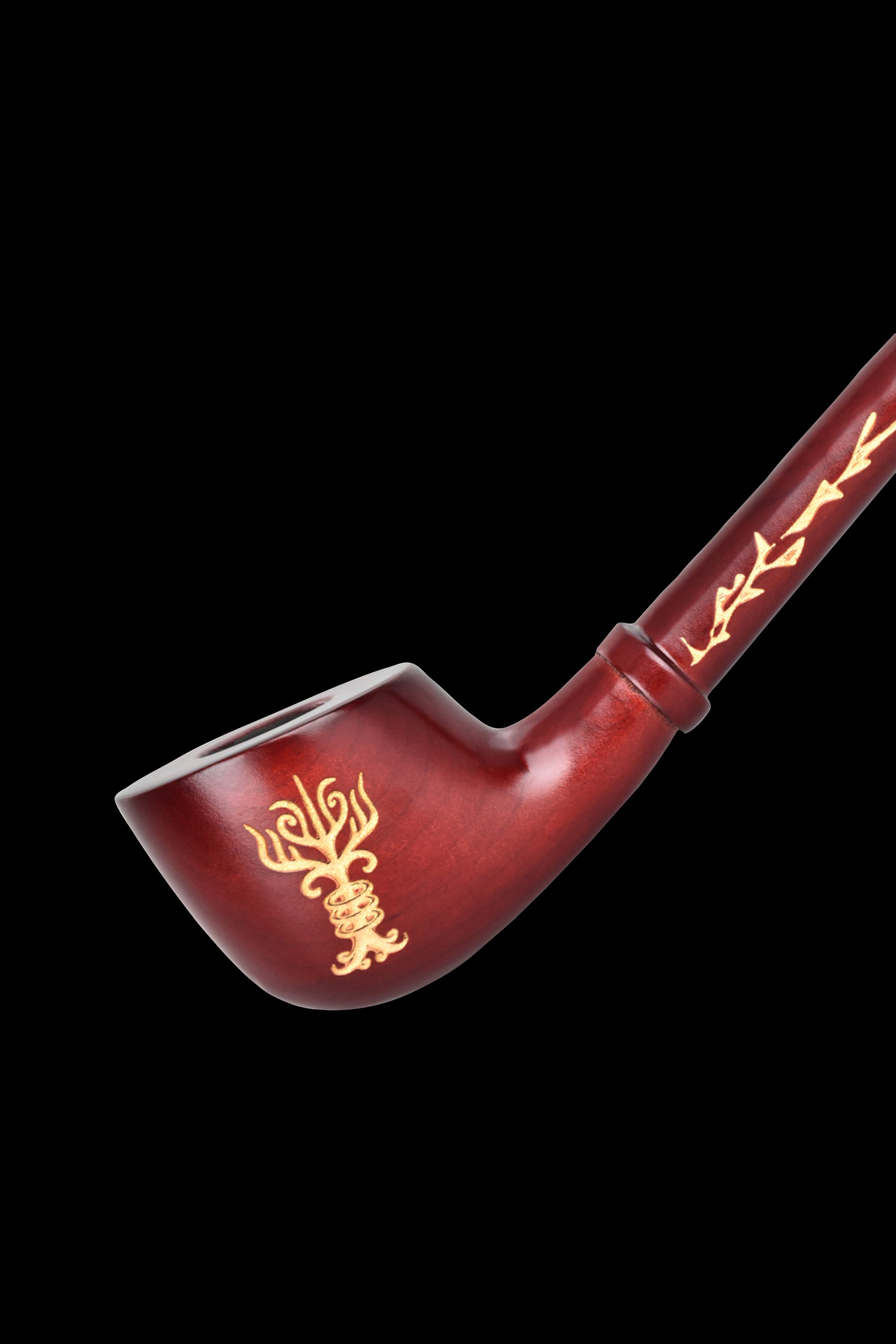 Red glass pipe with gold floral and geometric designs, isolated on a black background.