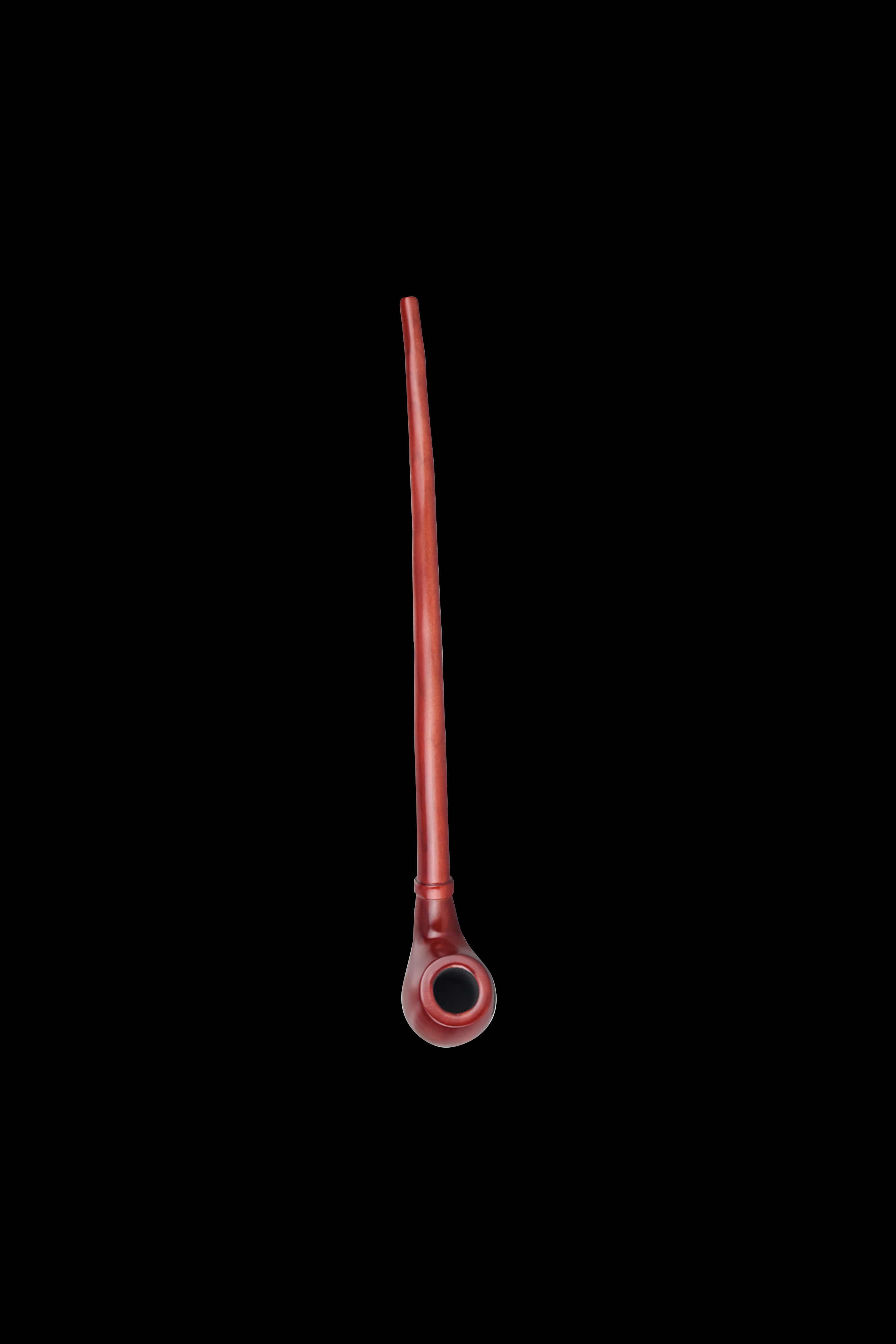 Red glass chillum pipe against a black background.