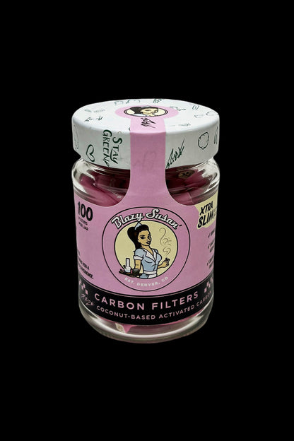 A glass jar of “Blazy Susan” carbon filters for cannabis smoking, featuring a vintage-style label with a woman in a headwrap and the text “100 Filters Per Jar.”