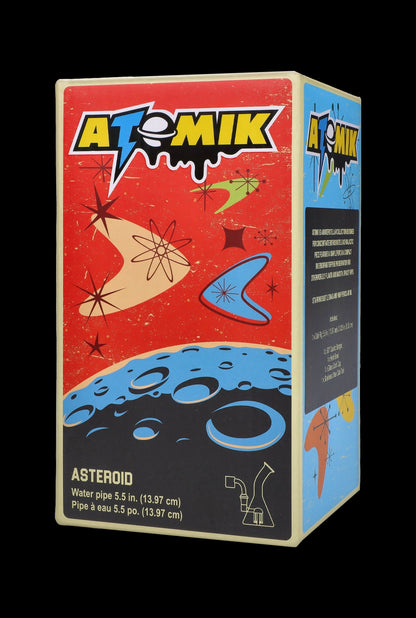 Box for “Atomik” brand water pipe, featuring a space-themed design with planets, stars, and text detailing product specifications.