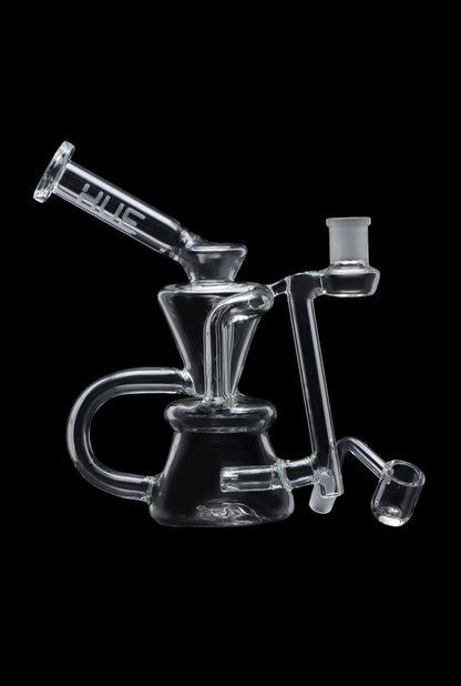 Angled side view of the Hue - Hourglass Dab Rig Clear - 7.5" showing its clear glass body, flared mouthpiece, and angled banger against a black background