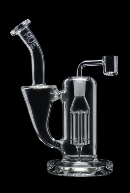 Clear glass dab rig with intricate percolator and quartz nail, isolated on a black background.