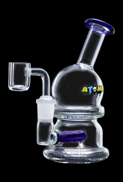 Clear glass dab rig with blue accents and a quartz banger, isolated on a black background.