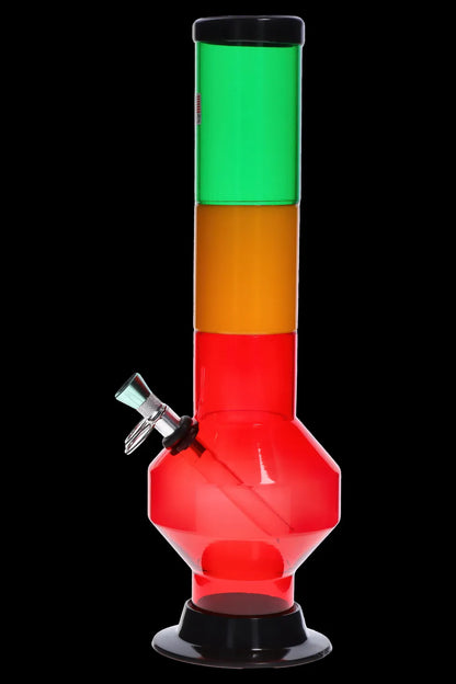 Front view of the JM Plastics Rasta Geometric with Pull Slide Acrylic Bong showing stacked green, yellow, and red geometric sections against a black background.