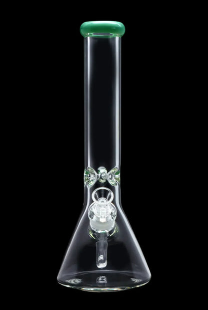 Clear glass beaker bong with green accents and percolators, isolated on a black background.