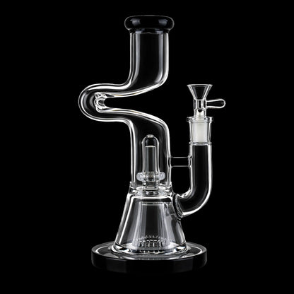 Close-up front view of the Smoke Cartel Zig Zag Dual Perc Bong - 9.2 in. showing its S-shaped clear glass neck, dual percolator chamber, and black-rimmed mouthpiece against a black background.
