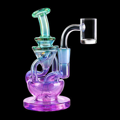 Angled close-up of the Smoke Cartel Swirly Recycler Dab Rig - 5.5 in. showing iridescent ombre green-to-purple glass tubes and a clear side-mounted banger against a black background