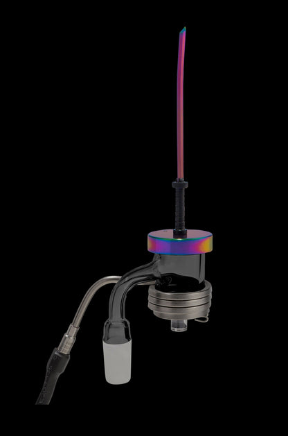 A vibrant, iridescent glass dab rig with a quartz banger and accompanying glass accessories against a black background.