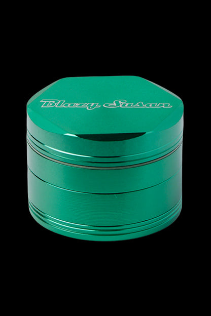 Green four-layer herb grinder with “Blazy Susan” logo.