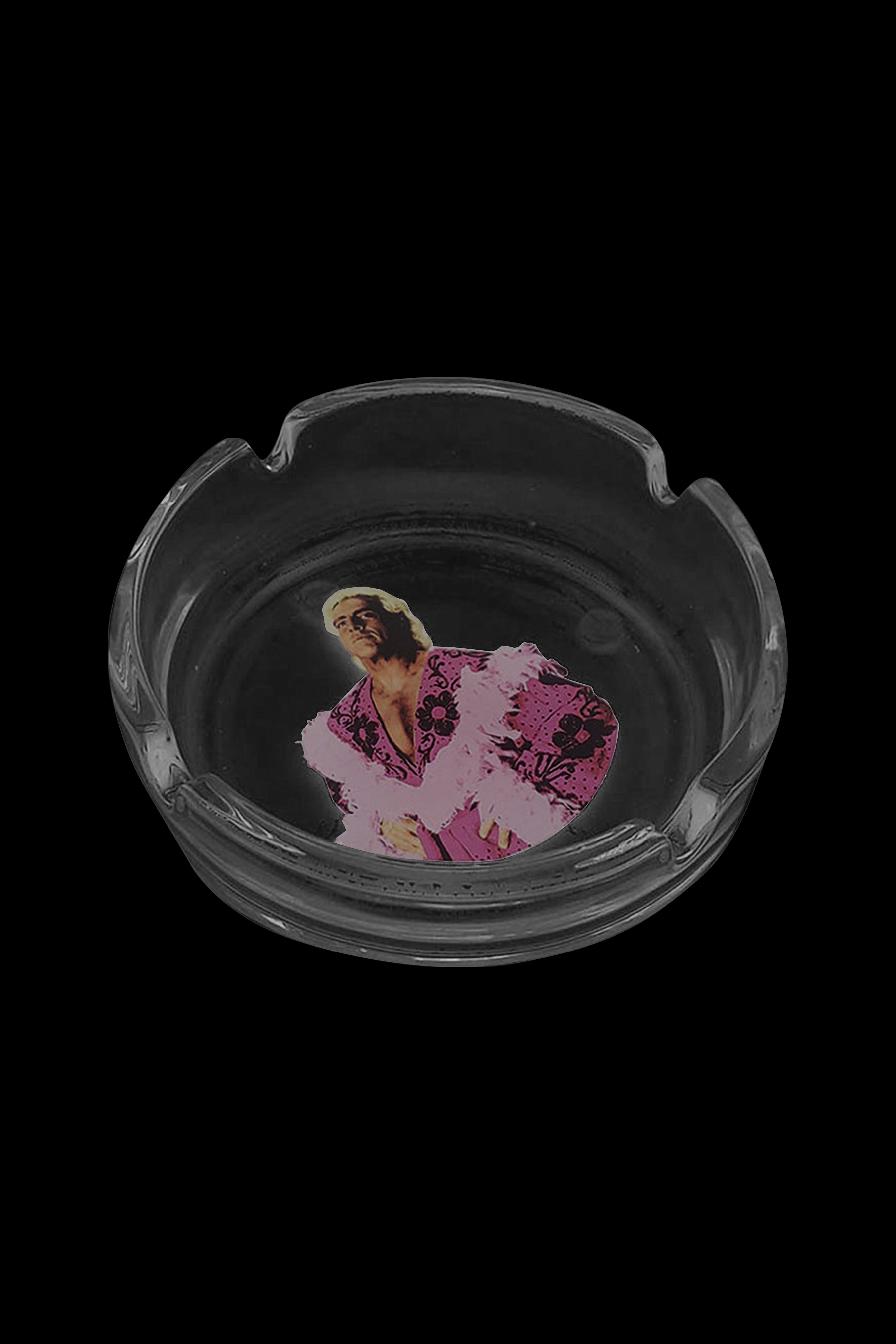 Glass ashtray with a colorful, stylized portrait of a woman inside.