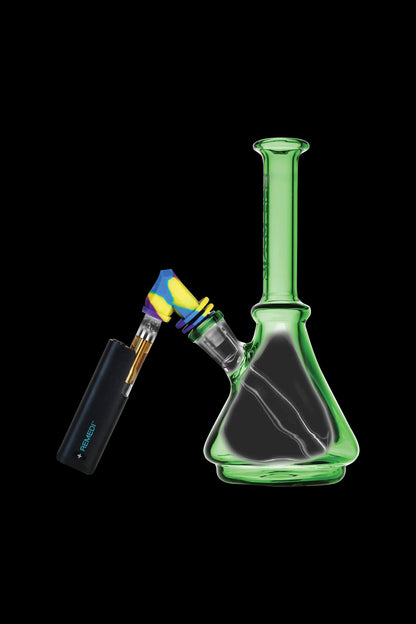 Green glass bubbler water pipe with a cannabis oil cartridge and lighter against a black background.