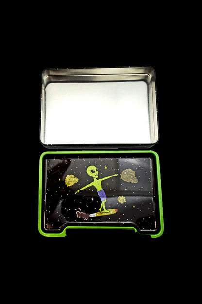 Open metal tin with a space-themed design featuring an alien surfing on a cannabis bud.