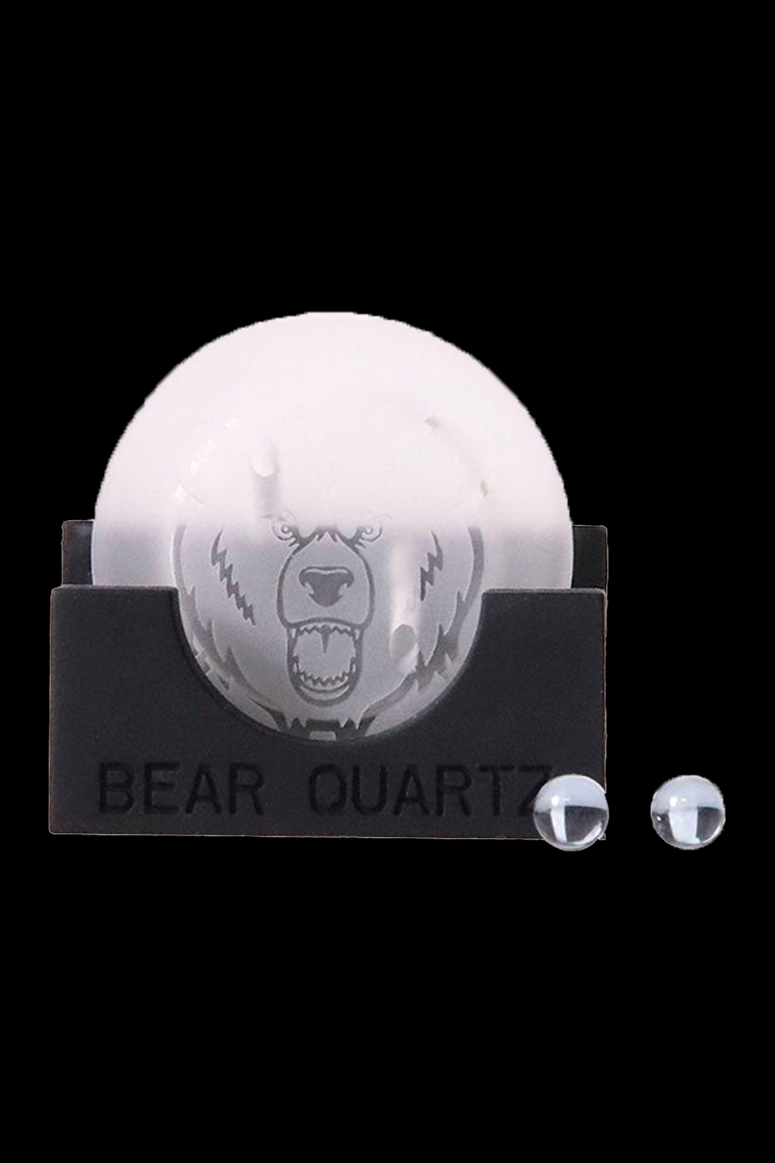 Clear quartz dab nail shaped like a bear’s head, packaged on black cardstock labeled “BEAR QUARTZ, ” with two extra quartz pieces beside it."
