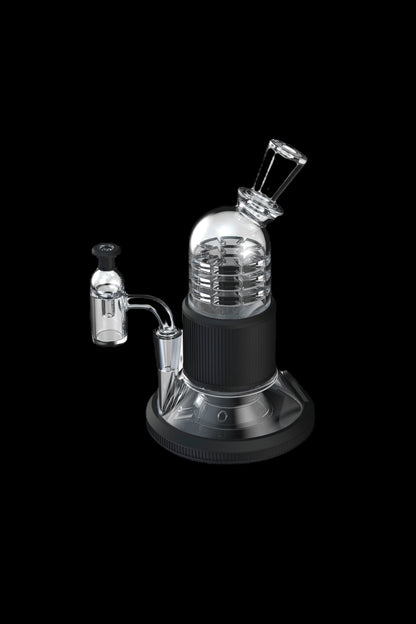 Black and clear glass dab rig with quartz banger and carb cap, isolated on a black background.