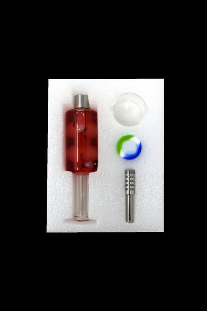 Red glass oil rig with accessories including a quartz banger, carb cap, and dab tool, displayed in foam packaging.