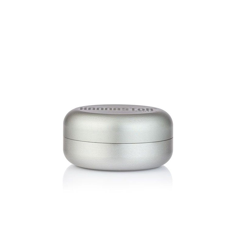 Centered studio shot of the RYOT GR8TR Solid Body Grinder in matte silver, shown closed on a white reflective surface