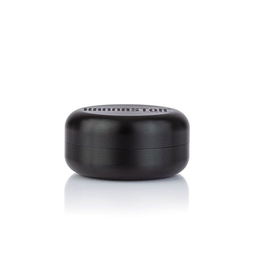 Centered front view of the black RYOT GR8TR Solid Body Grinder on a white background with a subtle reflection beneath it.