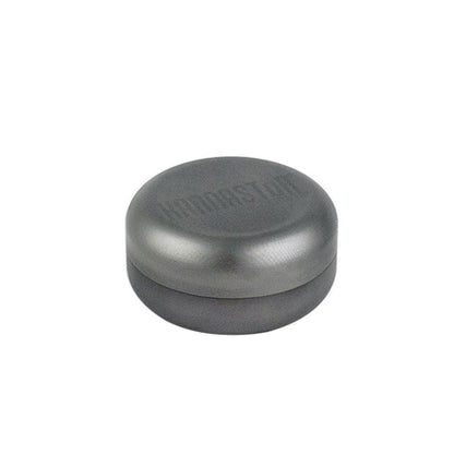 Top-down view of the round gray RYOT GR8TR Solid Body Grinder resting on a white background, showing its smooth lid.