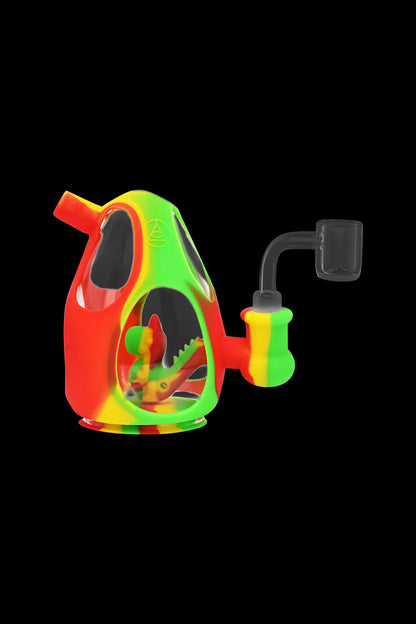 Colorful silicone water pipe (rig) with a dinosaur-shaped chamber and accompanying quartz banger.