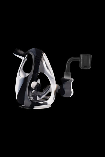 Clear glass dab rig with a quartz banger, isolated on a black background.