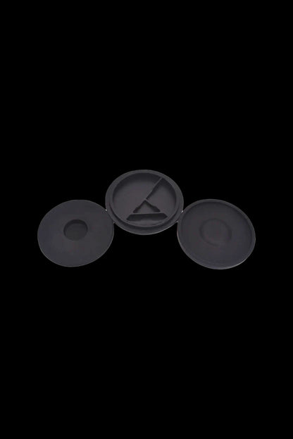 Three black silicone caps for cannabis oil cartridges.